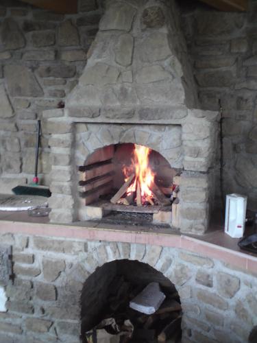a stone oven with a fire in it at Privat Julia in Vrbov