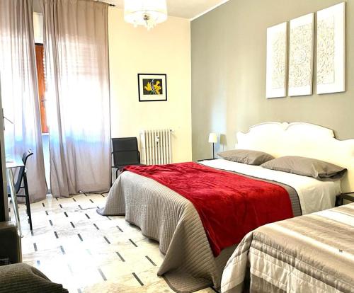 ターラントにあるRosa dei Venti B&Bのベッドルーム1室(ベッド2台、赤毛布付)