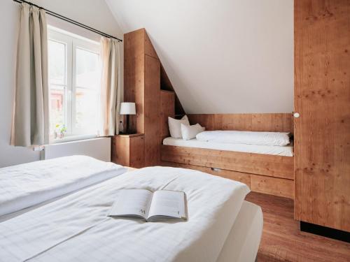 a bedroom with two beds and a book on the bed at Semi-detached houses, turf house in Torfhaus