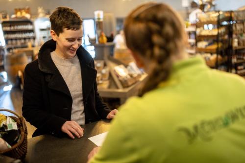 a man and a woman sitting at a counter in a store at Hotel Ehlers in Schneverdingen