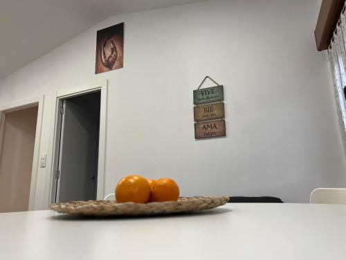 a bowl of oranges sitting on a white counter at Atico El Lagar de Labastida in Labastida