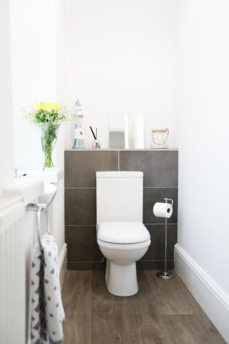 a bathroom with a white toilet and a sink at Woodside Oak hot tub & pool sleeps 4-6 in Bideford