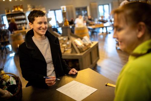 two people sitting at a table in a store at Hotel Ehlers in Schneverdingen