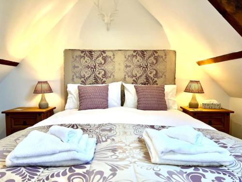 a bedroom with a bed with towels on it at Hectors House, Rothbury in Rothbury