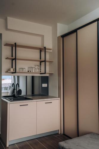 a kitchen with a white cabinet and a stove at Leon Luxury Apartments in Ohrid