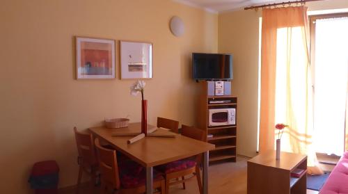 a living room with a table and a tv at Apartmán Oščadnica in Oščadnica