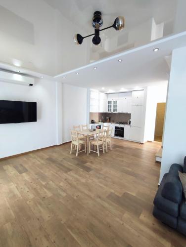 a kitchen and dining room with a table and chairs at European Village Old Villa 6 in Gonio