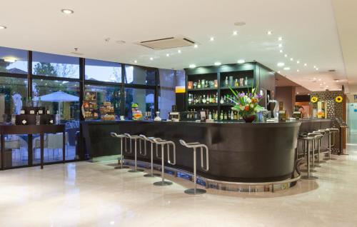a bar in a restaurant with stools at Senator Banus in Estepona