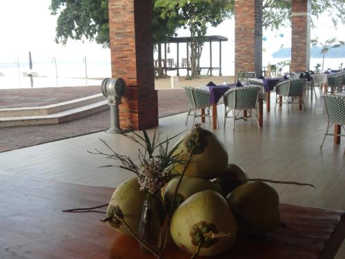 a vase of coconuts on a table in a restaurant at Anema Wellness & Resort Gili Lombok - Diving Center PADI in Tanjung