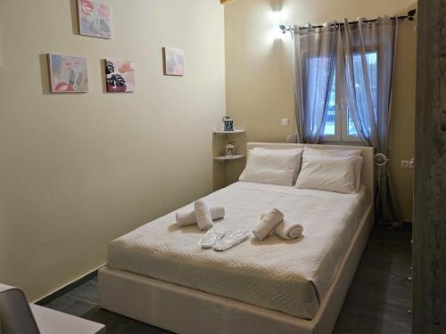 a bedroom with a bed with two towels on it at Elia Paradise Villa with Pool in Heraklio Town