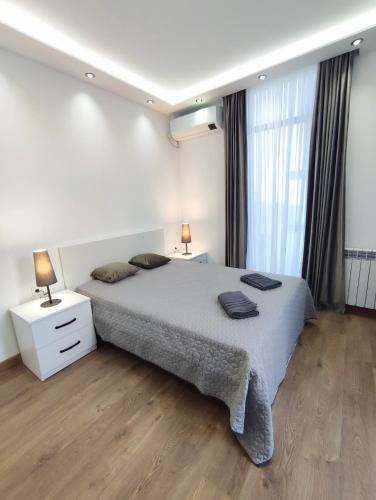 a bedroom with a large bed with two lamps on it at European Village Old Villa 6 in Gonio