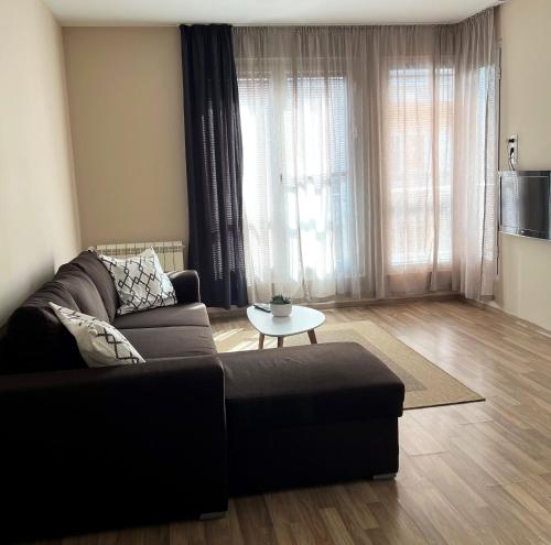a living room with a couch and a table at Lubata 5 Apartments - 2 bedrooms in Sofia