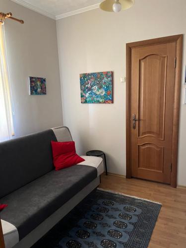 a living room with a couch and a wooden door at Garden house in Daugavpils