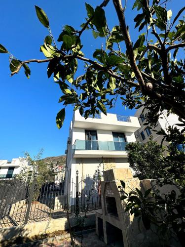 a white building with a fence in front of it at European Village Old Villa 6 in Gonio