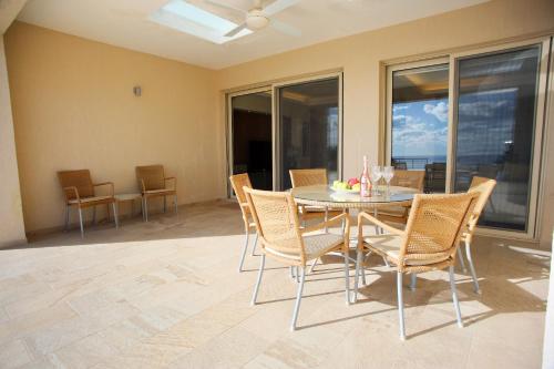 a dining room with a table and chairs at Seafront 5 Bedroom Villa Paradise in Sea Caves in Peyia