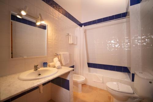 a bathroom with a sink and a toilet and a shower at Bimbolla Apartaments in Punta Prima