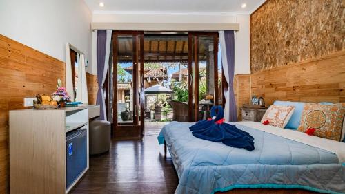 เตียงในห้องที่ Kun - Kun Guest House Ubud