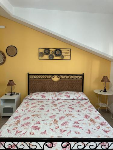 a bedroom with a bed and two tables and two lamps at Il Bacio del Mare in Agropoli