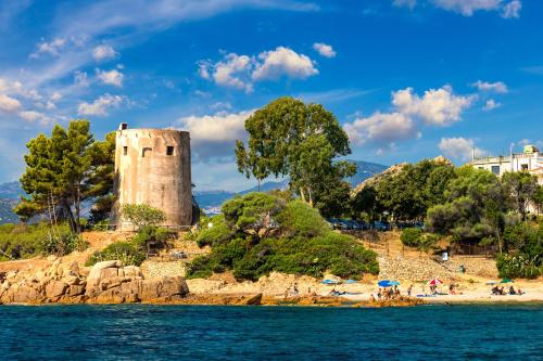 a castle on the shore of a body of water at Le Corti Sarde Countryside in Bari Sardo