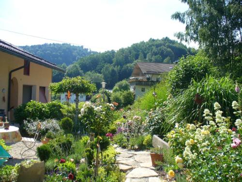 un jardín con muchas flores y plantas diferentes en Freyung, Ferienwohnung Sonnenschein en Schönberg