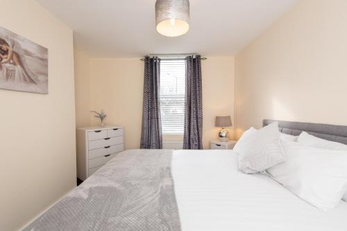 a bedroom with a white bed and a window at Number 46 in Langley Park