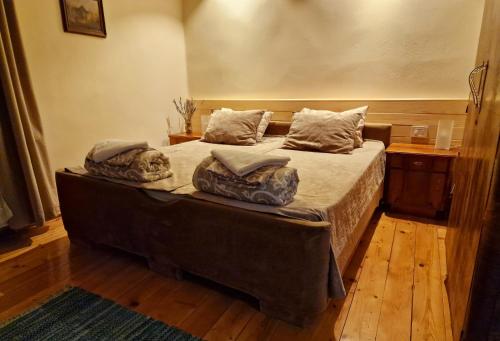 a bedroom with a large bed with pillows on it at Konak -Guest house -Ramonda Serbika in Niš