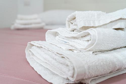 a pile of white towels sitting on a table at La casa di Thomas in centro in Matera