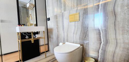 a bathroom with a white toilet and a sink at SeaNet Hotel By AFI Hotels in Tel Aviv