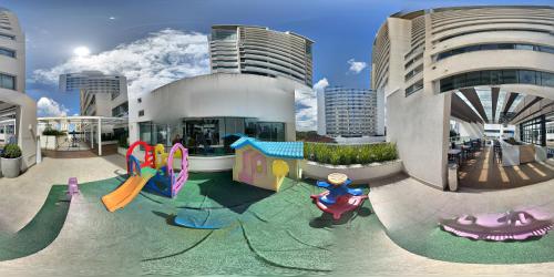 a playground in front of a building at América apart-hotel in Campos dos Goytacazes