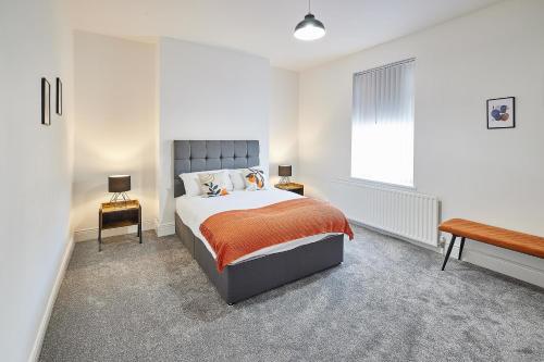 a white bedroom with a bed and a window at Host & Stay - North Seaton Road in Newbiggin-by-the-Sea