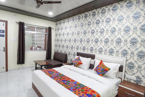 a bedroom with a large bed in a room at FabHotel Rajdhani in Kānpur
