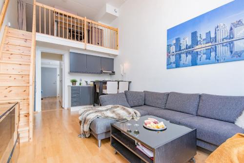 a living room with a couch and a table at Super central - Unique studio apartment - 4 people in Oslo