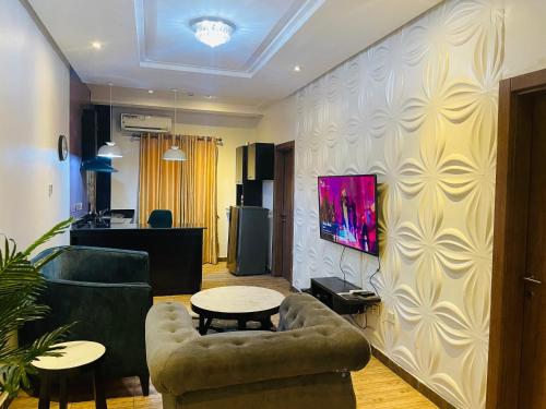 a living room with a couch and a table at James Court Hotel & Luxury Apartments in Lekki