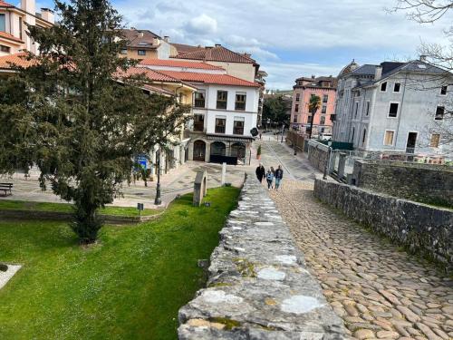 a group of people walking down a cobblestone street at Apartamento Bautista Centro in Cangas de Onís