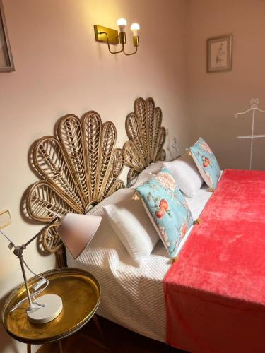 a bedroom with a large bed with a red table at Apartamento Bautista Centro in Cangas de Onís