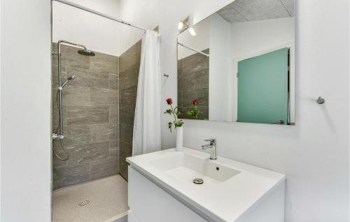 a white bathroom with a sink and a shower at Holiday Home Alrum Tim Iii in Tim