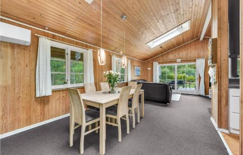 a dining room with a table and chairs at Holiday Home Alrum Tim Iii in Tim