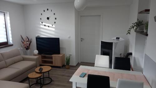 a living room with a couch and a table at Gogo in Delnice
