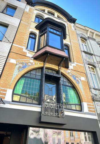 a building with a balcony on the side of it at 3 Bedroom Art-Nouveau Apartment with Free Parking in Ghent