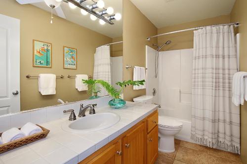 a bathroom with a sink and a toilet at Regency at Poipu Kai 323 in Koloa