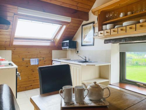 a kitchen with a table with two mugs on it at Valencourt - 18426 in Rosedale Abbey