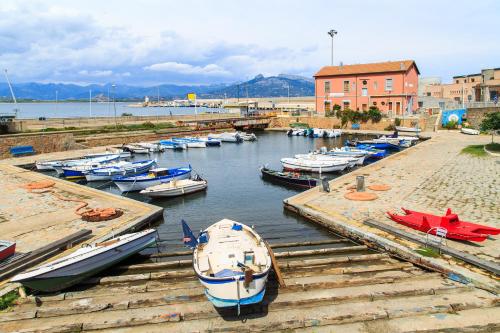 a bunch of boats are docked in a harbor at Le Corti Sarde Apartments in Bari Sardo