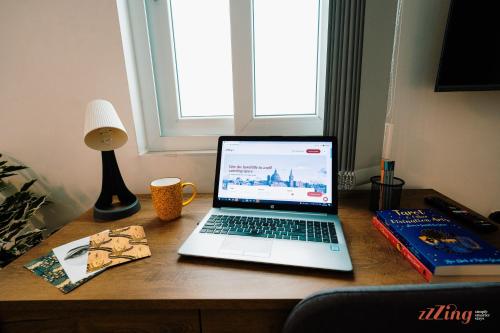 a laptop computer sitting on top of a desk at A Modern Maltese Townhouse in Siggiewi in Siġġiewi