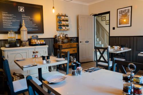 a dining room with tables and chairs and a chalkboard at Number 46 in Hastings