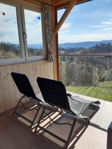two chairs and a table in a room with windows at Ferienhaus Urschitz in Eichberg Arnfels