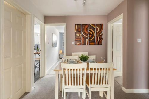 a kitchen and dining room with a table and chairs at Southcliff Retreat in Scarborough