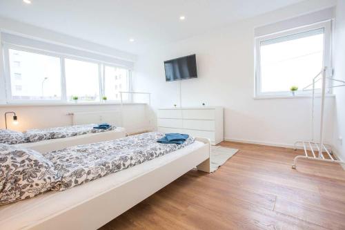 Un pat sau paturi într-o cameră la Cozy & Modern Apartments