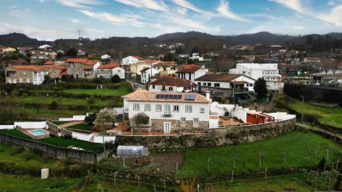 a village with a large white house in a field at Portugal countryside retreat for remote workers and digital nomads in Vale de Cambra