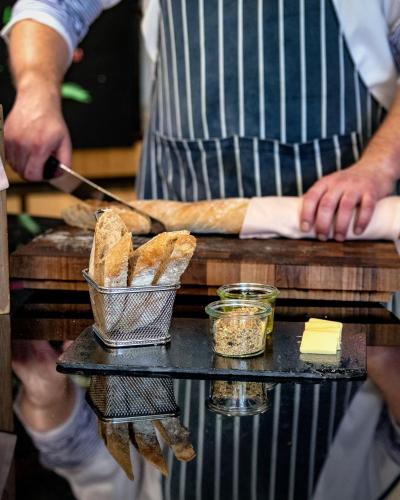 a person is making bread on a table with a table at ibis Styles Warszawa Centrum in Warsaw