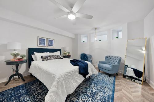 a bedroom with a bed and a blue chair at Beautiful Condo Steps from Shoreline Park - A in Sandusky